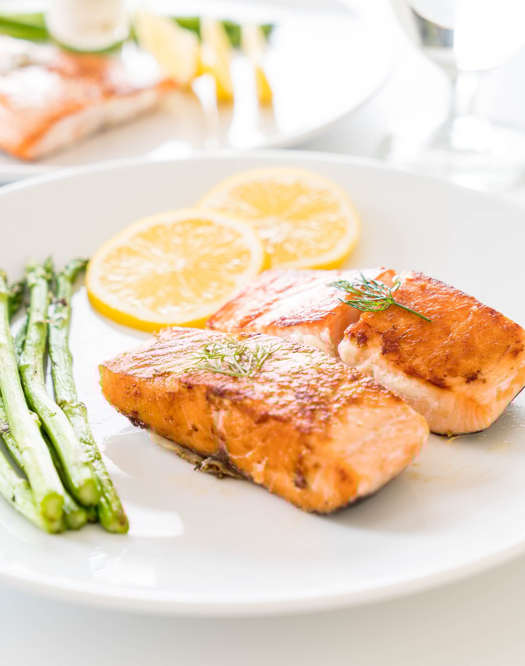 Grilled Salmon Steak with Lemon and Asparagus on a Plate